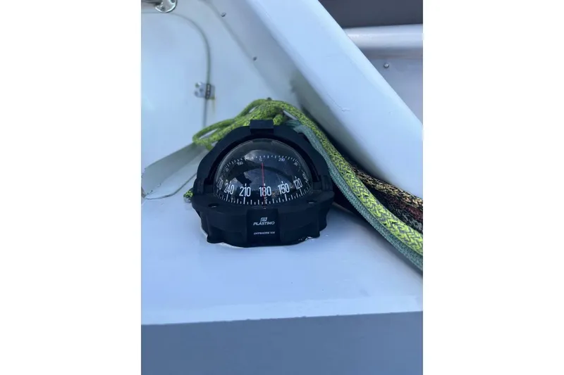 Slide: The Image of Compass on Akilaria RC2 Class 40 yacht, 2009 model, with green rope nearby. - 55