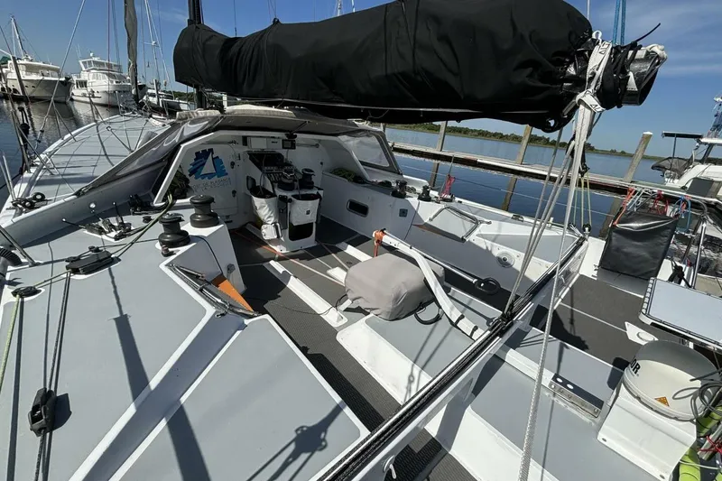 Slide: The Image of 2009 Akilaria RC2 Class 40 sailboat cockpit, docked at marina under clear blue sky. - 57