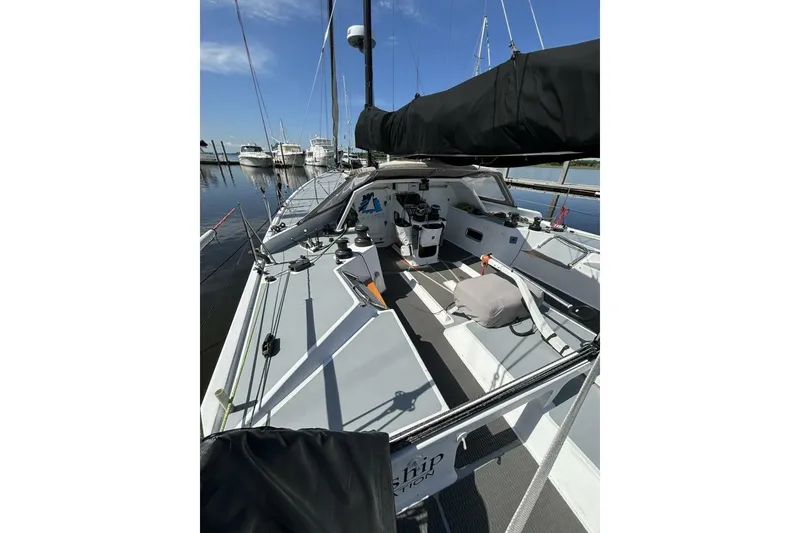 Slide: The Image of 2009 Class 40 Akilaria RC2 sailboat docked, showcasing sleek deck design and rigging. - 58