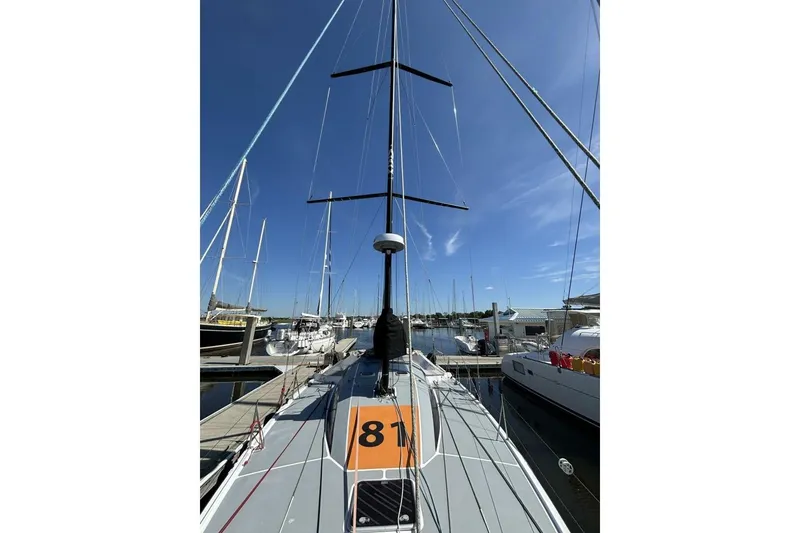 Slide: The Image of Sailboat Akilaria RC2 Class 40, 2009 model, docked at marina under clear blue sky. - 63