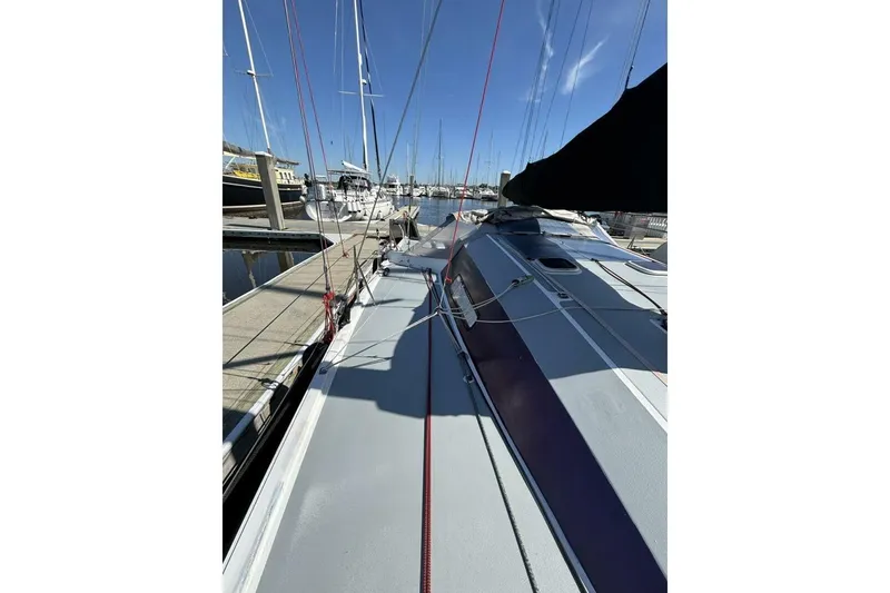 Slide: The Image of 2009 Class 40 Akilaria RC2 sailboat docked at marina, showcasing deck and rigging. - 65
