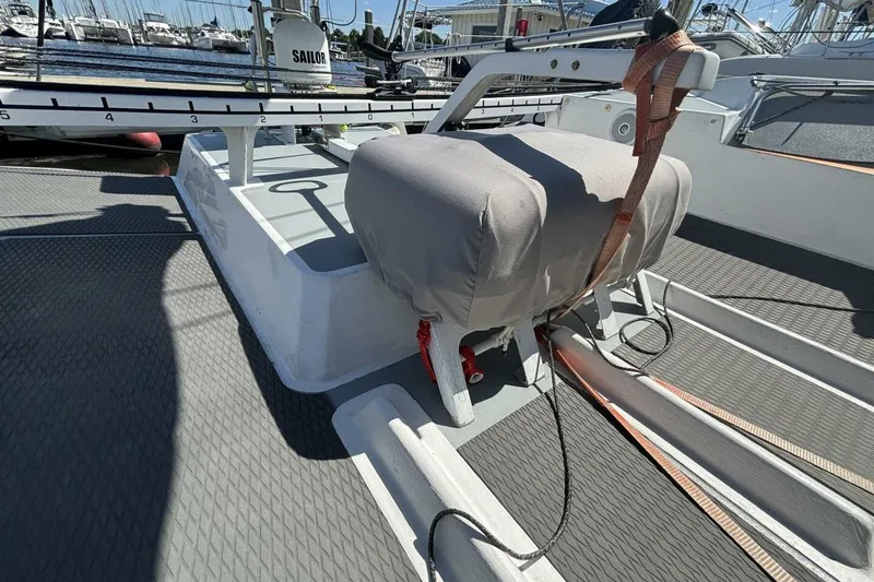 Slide: The Image of 2009 Class 40 Akilaria RC2 yacht deck with covered equipment and marina background. - 72