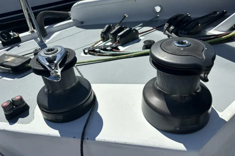 Slide: The Image of Winches on 2009 Class 40 Akilaria RC2 sailboat deck, with ropes and controls. - 74