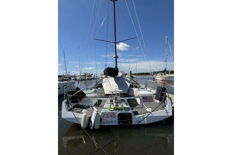 Slide: The Image of 2009 Class 40 Akilaria RC2 sailboat docked at marina under clear blue sky. - 79