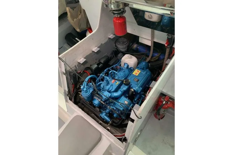 Slide: The Image of Engine compartment of 2009 Class 40 Akilaria RC2 sailboat, featuring a blue marine engine. - 8