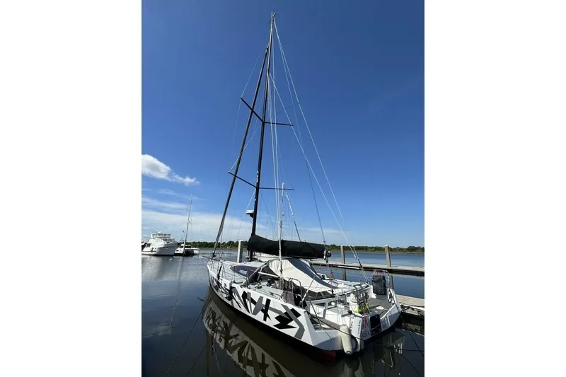Slide: The Image of Sailboat Akilaria RC2 Class 40, 2009 model, docked under clear blue sky. - 81
