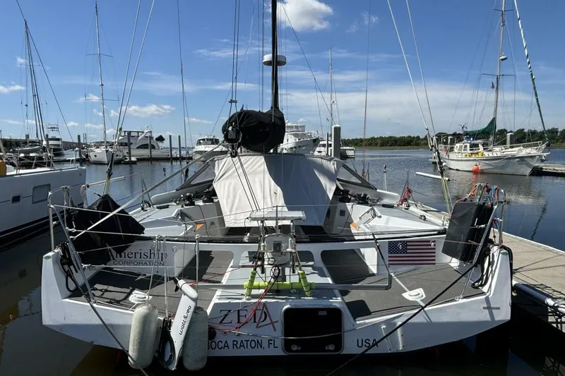 Slide: The Image of Sailboat docked at marina, Class 40 Akilaria RC2, 2009 model, with American flag. - 82