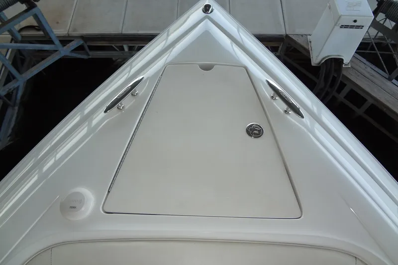 Slide: The Image of Bow of a 2008 Cobalt 302 boat, featuring sleek white design and stainless steel fittings. - 10