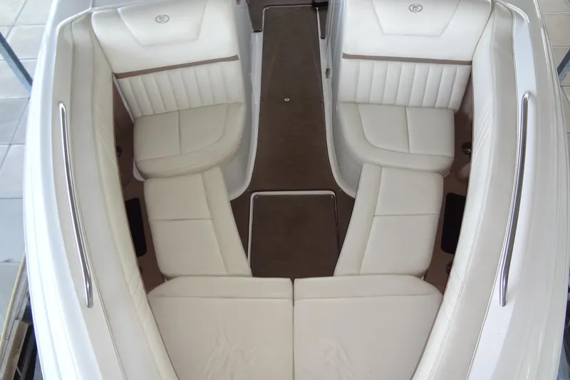 Slide: The Image of 2008 Cobalt 302 boat interior with white leather seating and sleek design. - 12