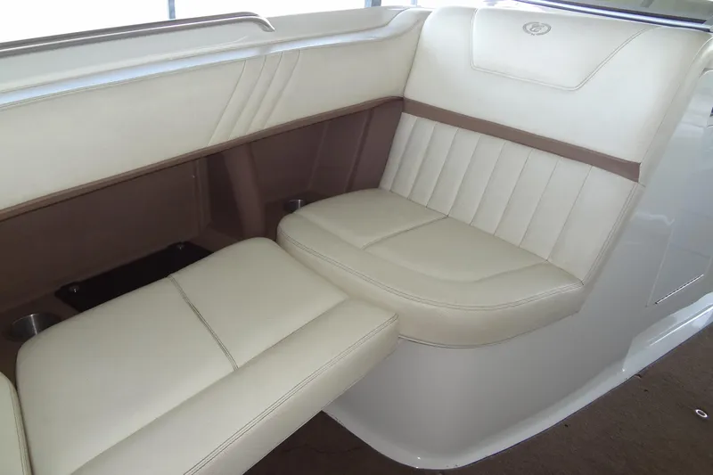 Slide: The Image of Luxurious seating in a 2008 Cobalt 302 boat, featuring cream and brown upholstery. - 13
