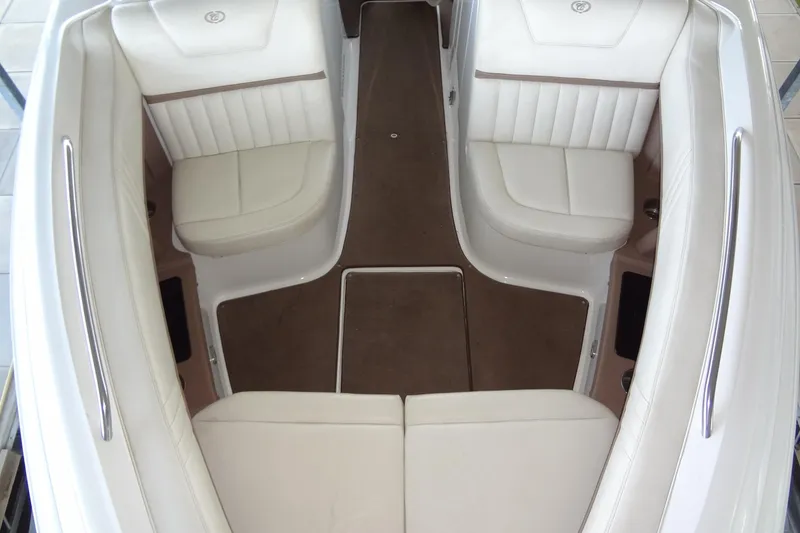 Slide: The Image of Interior of a 2008 Cobalt 302 boat with white seating and brown flooring. - 16