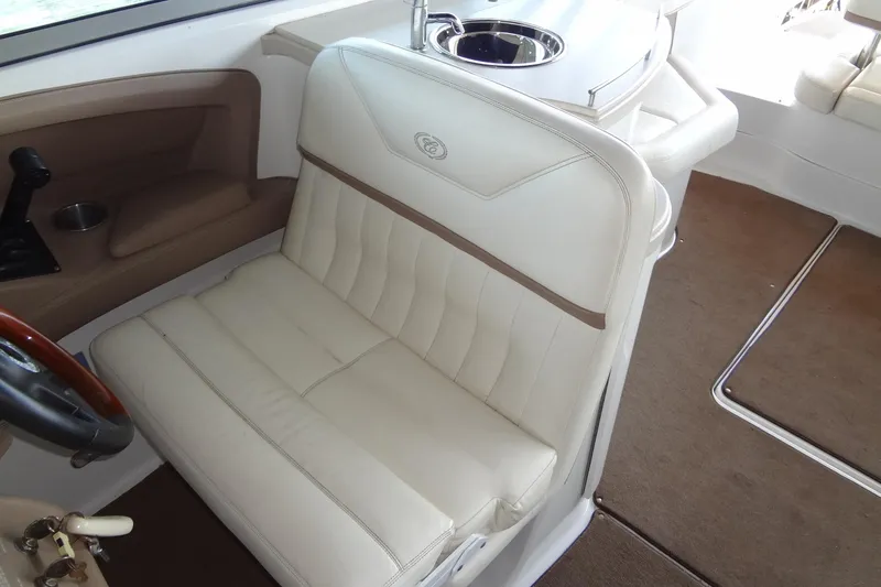 Slide: The Image of 2008 Cobalt 302 boat interior with beige leather seating and brown carpet. - 17
