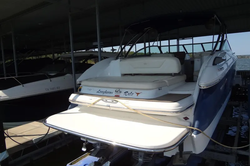 Slide: The Image of 2008 Cobalt 302 boat docked, featuring a spacious deck and sleek design. - 2