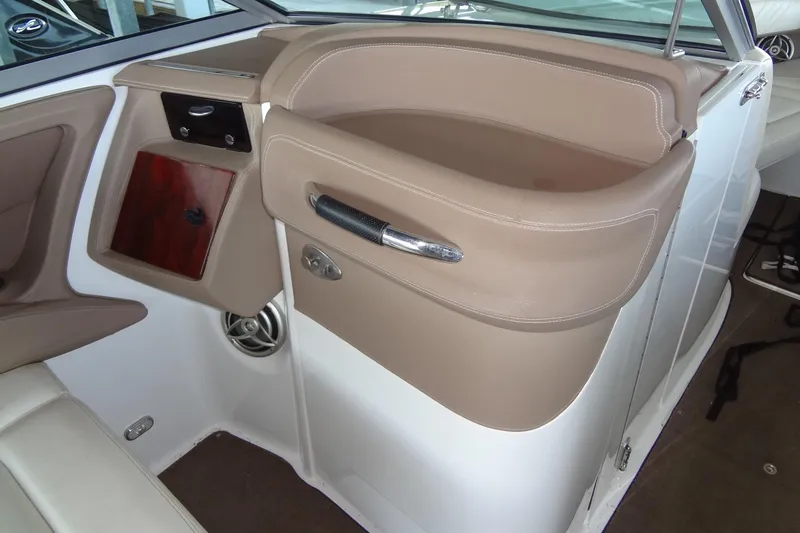 Slide: The Image of 2008 Cobalt 302 boat interior with beige leather seating and wooden accents. - 22
