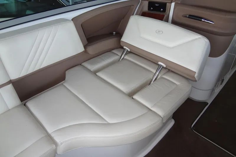 Slide: The Image of Luxurious interior seating of a 2008 Cobalt 302 boat, featuring cream and brown upholstery. - 25