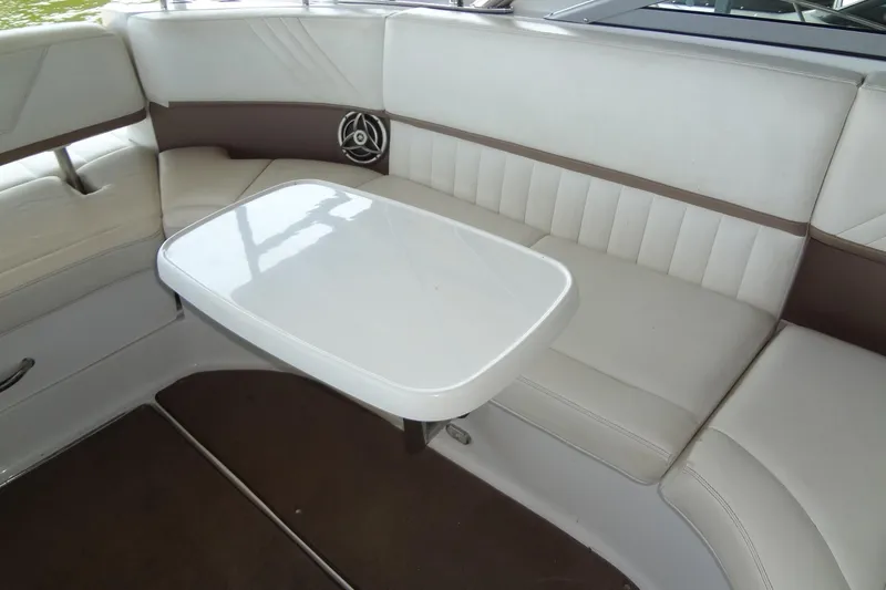 Slide: The Image of Interior of 2008 Cobalt 302 boat with white seating and table. - 27