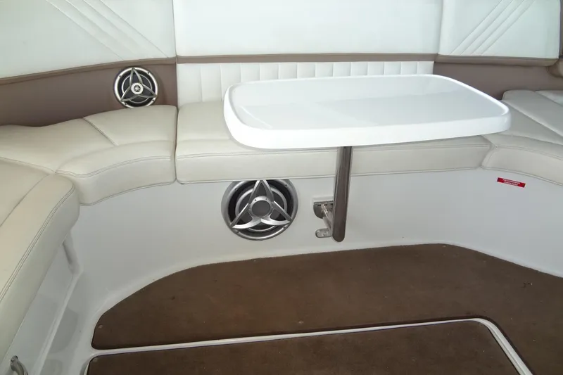 Slide: The Image of 2008 Cobalt 302 boat interior with white seating, table, and speakers. - 28