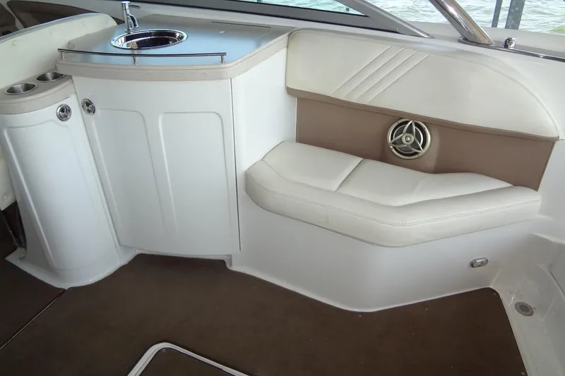 Slide: The Image of Interior of a 2008 Cobalt 302 boat featuring a sink and cushioned seating. - 30