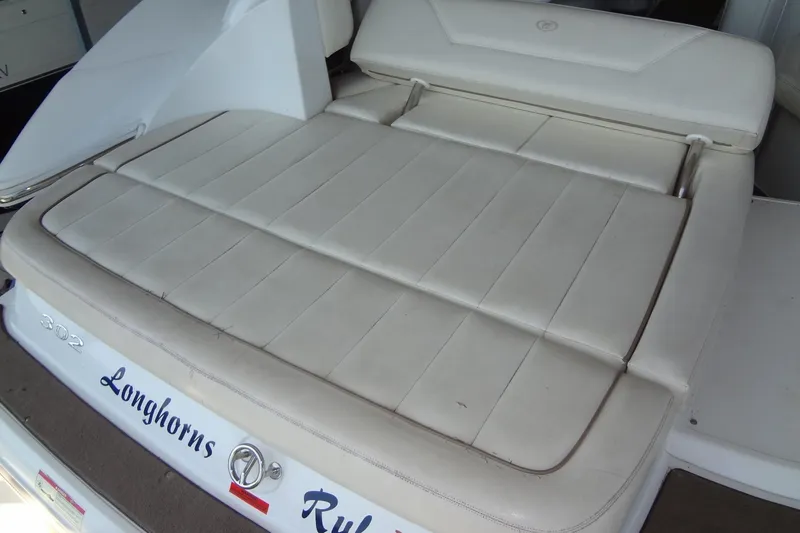 Slide: The Image of 2008 Cobalt 302 boat with white cushioned seating and "Longhorns" text on the back. - 32