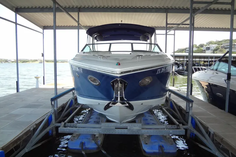 Slide: The Image of 2008 Cobalt 302 boat docked in a covered marina, front view. - 4