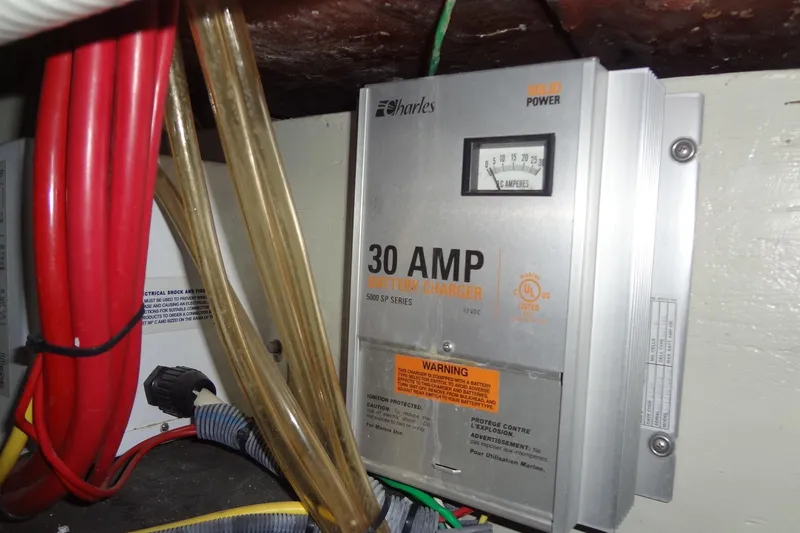 Slide: The Image of 30 AMP battery charger in a 2008 Cobalt 302 boat, surrounded by cables. - 47