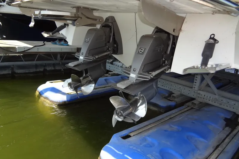 Slide: The Image of 2008 Cobalt 302 boat with dual outboard motors on a dock lift. - 52