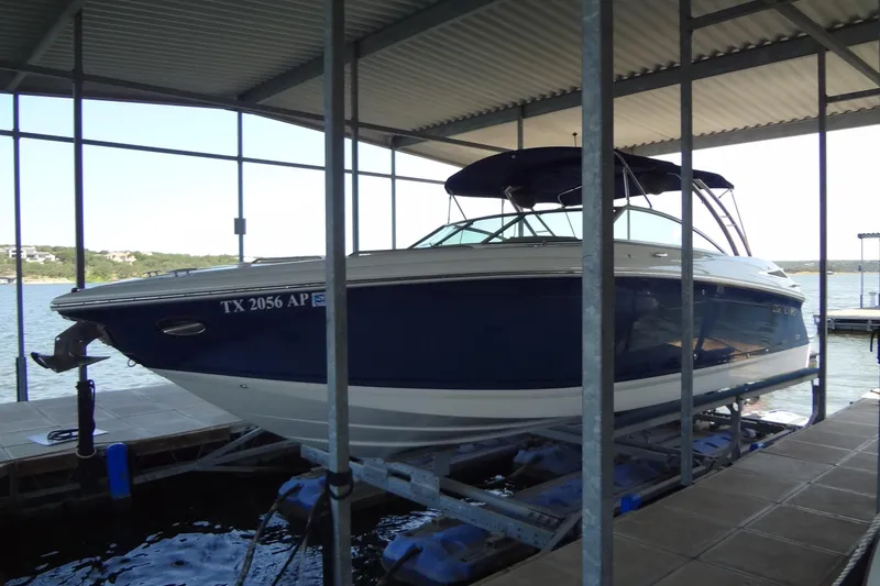 Slide: The Image of 2008 Cobalt 302 boat docked in a covered marina, side view. - 6