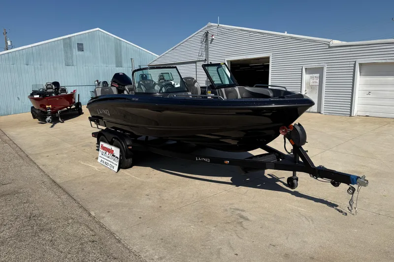 Slide: The Image of 2026 Lund 189 Tyee GL boat on trailer outside a marine dealership. - 1