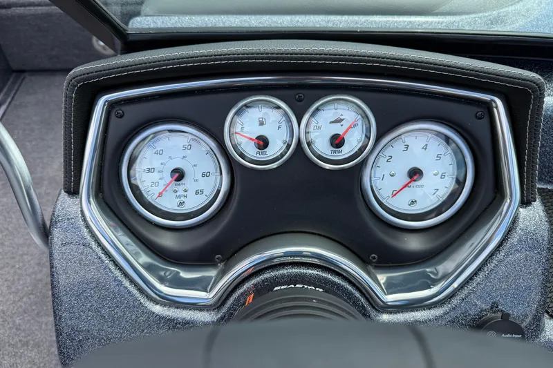 Slide: The Image of 2025 Lund 189 Tyee GL boat with seating and windshield, parked outdoors. - 18