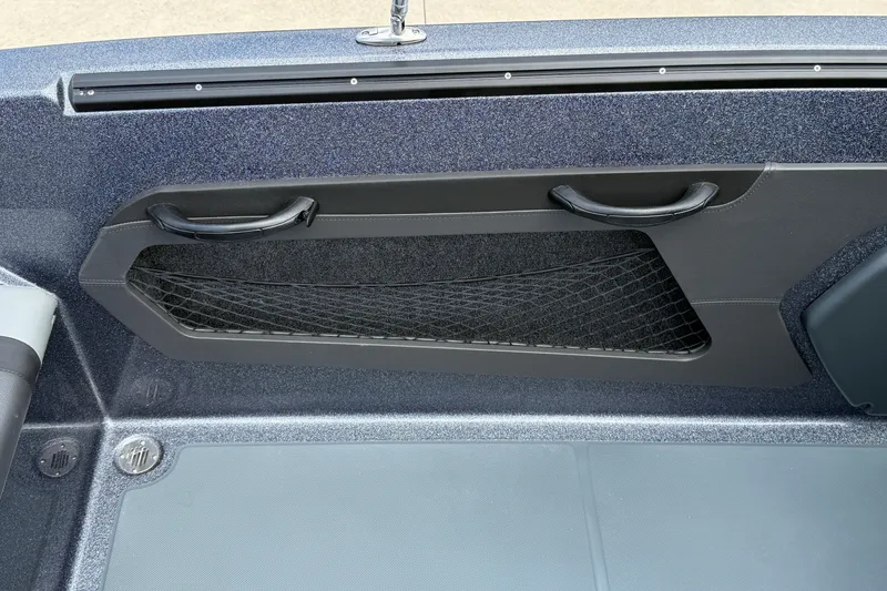 Slide: The Image of 2025 Lund 189 Tyee GL boat interior with storage compartment and sleek design. - 25