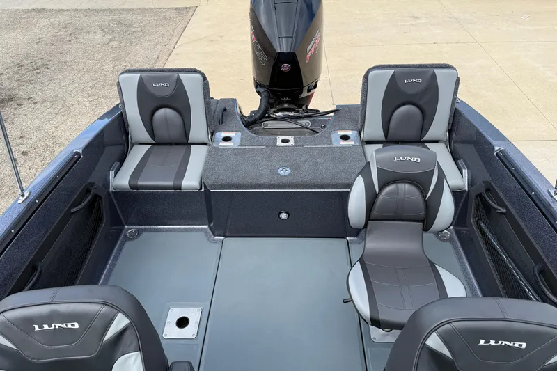 Slide: The Image of 2025 Lund 189 Tyee GL boat dashboard with open storage compartment. - 26