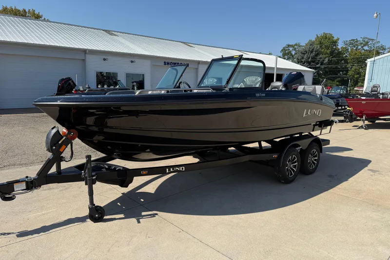 Slide: The Image of 2026 Lund 189 Tyee GL boat on trailer, parked outside showroom. - 3