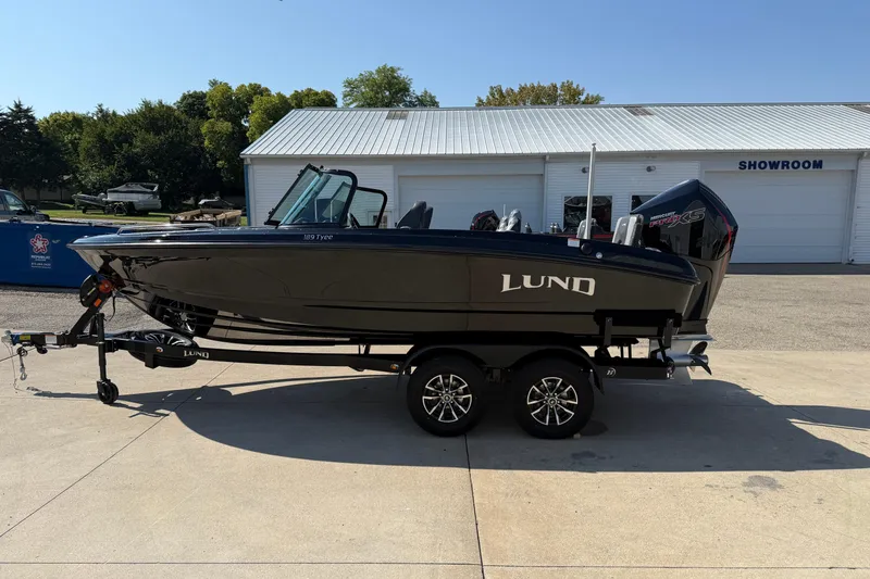 Slide: The Image of 2026 Lund 189 Tyee GL boat on trailer outside showroom, side view. - 4
