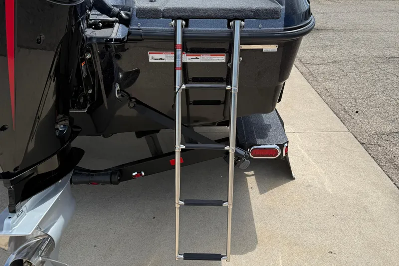 Slide: The Image of 2026 Lund 189 Tyee GL boat with V8 engine, parked outdoors on a sunny day. - 6