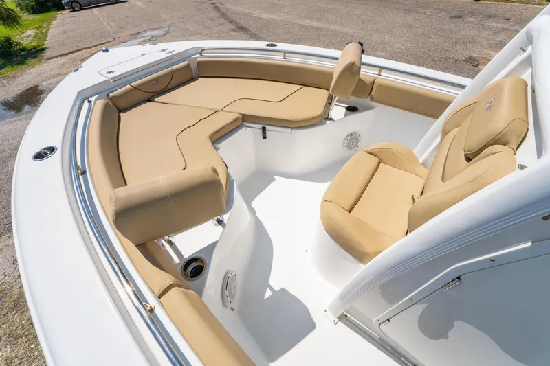 Slide: The Image of 2017 Sea Hunt Ultra 225 boat interior with tan cushioned seating and white deck. - 10