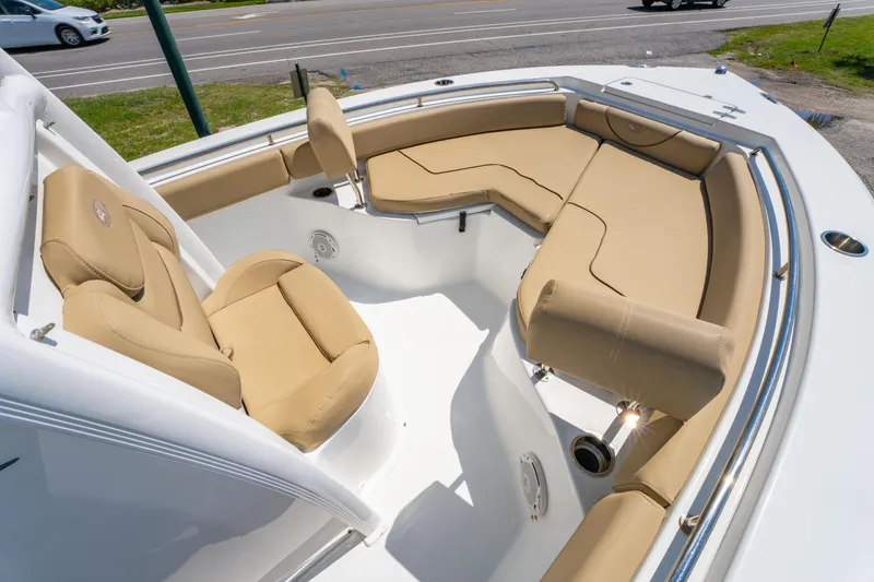 Slide: The Image of 2017 Sea Hunt Ultra 225 boat with tan cushioned seating and sleek design. - 11