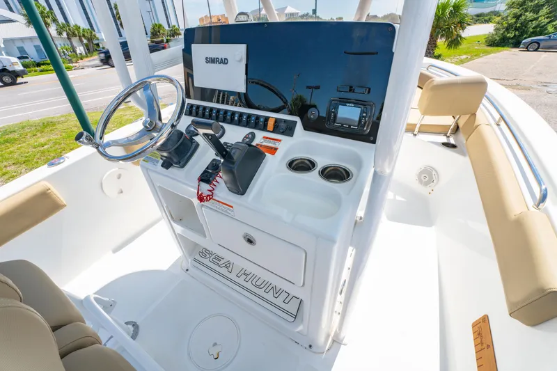 Slide: The Image of 2017 Sea Hunt Ultra 225 boat console with steering wheel and navigation equipment. - 16