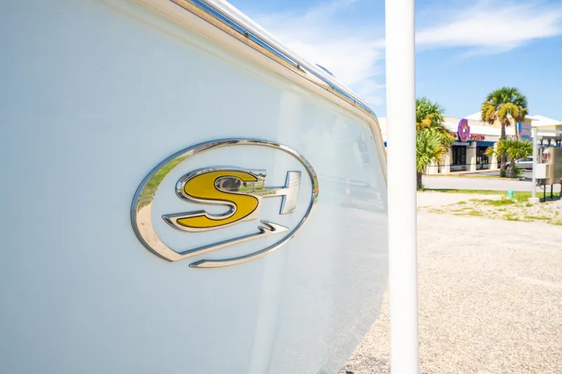 Slide: The Image of 2017 Sea Hunt Ultra 225 boat with logo, parked outdoors on a sunny day. - 18