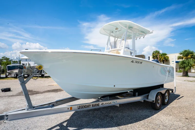 Slide: The Image of 2017 Sea Hunt Ultra 225 boat on trailer under clear blue sky. - 2