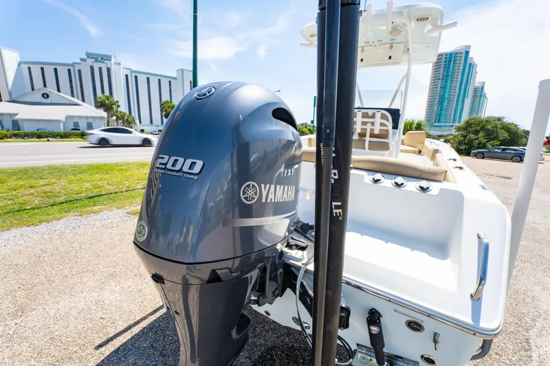 Slide: The Image of 2017 Sea Hunt Ultra 225 boat with Yamaha 200 engine, parked near modern buildings. - 20