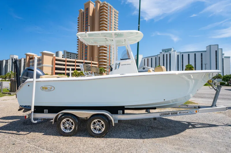 Slide: The Image of 2017 Sea Hunt Ultra 225 boat on trailer, urban background, clear sky. - 3