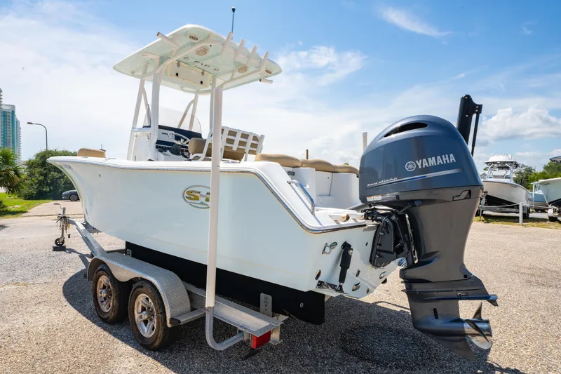 Slide: The Image of 2017 Sea Hunt Ultra 225 boat on trailer with Yamaha outboard motor, parked outdoors. - 8
