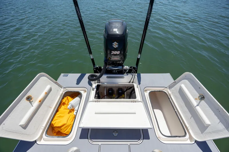 Slide: The Image of 2008 Release Tarpen Bay 21 boat with open storage compartments and 300 horsepower engine. - 11