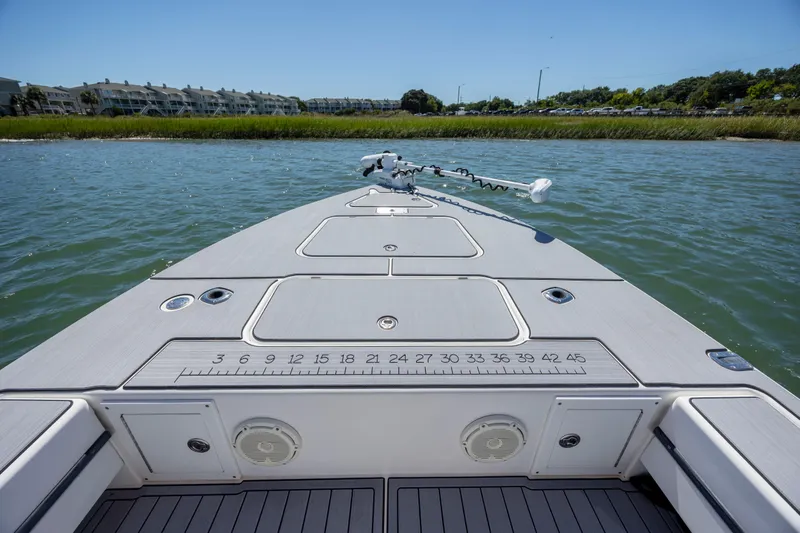 Slide: The Image of Bow view of 2008 Release Tarpen Bay 21 boat on water, featuring deck and storage compartments. - 17