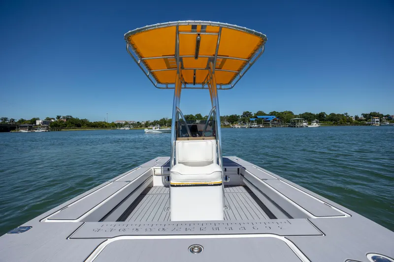 Slide: The Image of 2008 Release Tarpen Bay 21 boat with yellow canopy on calm water. - 18