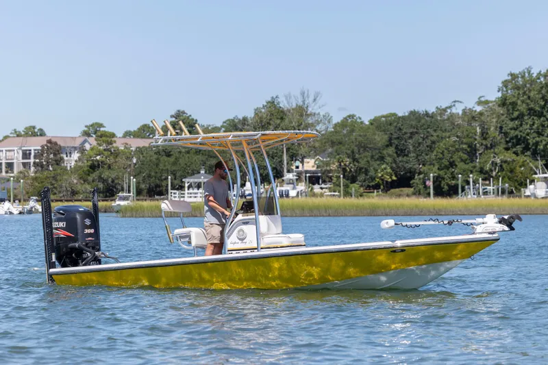 Slide: The Image of 2008 Release Tarpen Bay 21 boat on water, featuring Suzuki 300 engine, scenic background. - 4