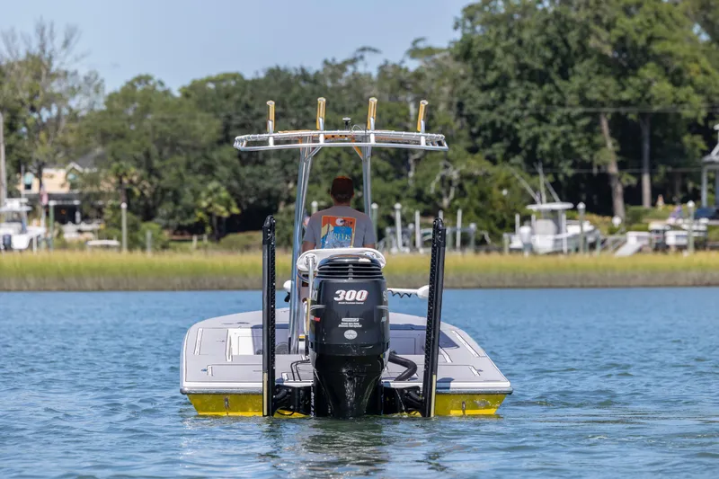 Slide: The Image of 2008 Release Tarpen Bay 21 boat on water, rear view with outboard motor. - 8