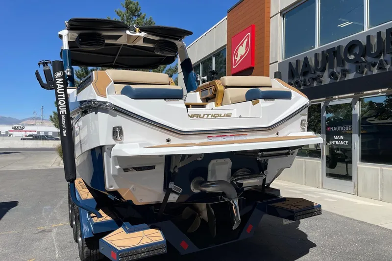 Slide: The Image of 2024 Nautique Super Air Nautique G25 Paragon boat displayed outside dealership. - 3