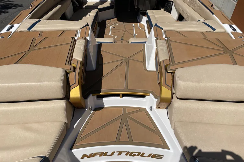 Slide: The Image of 2024 Nautique Super Air Nautique G25 Paragon interior with beige seating and stylish deck design. - 4