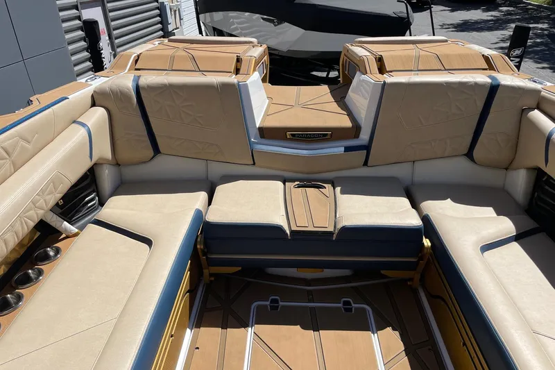 Slide: The Image of 2024 Nautique Super Air Nautique G25 Paragon interior with luxurious seating and cup holders. - 8